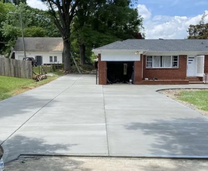 Concrete driveway beside a brick ranch home